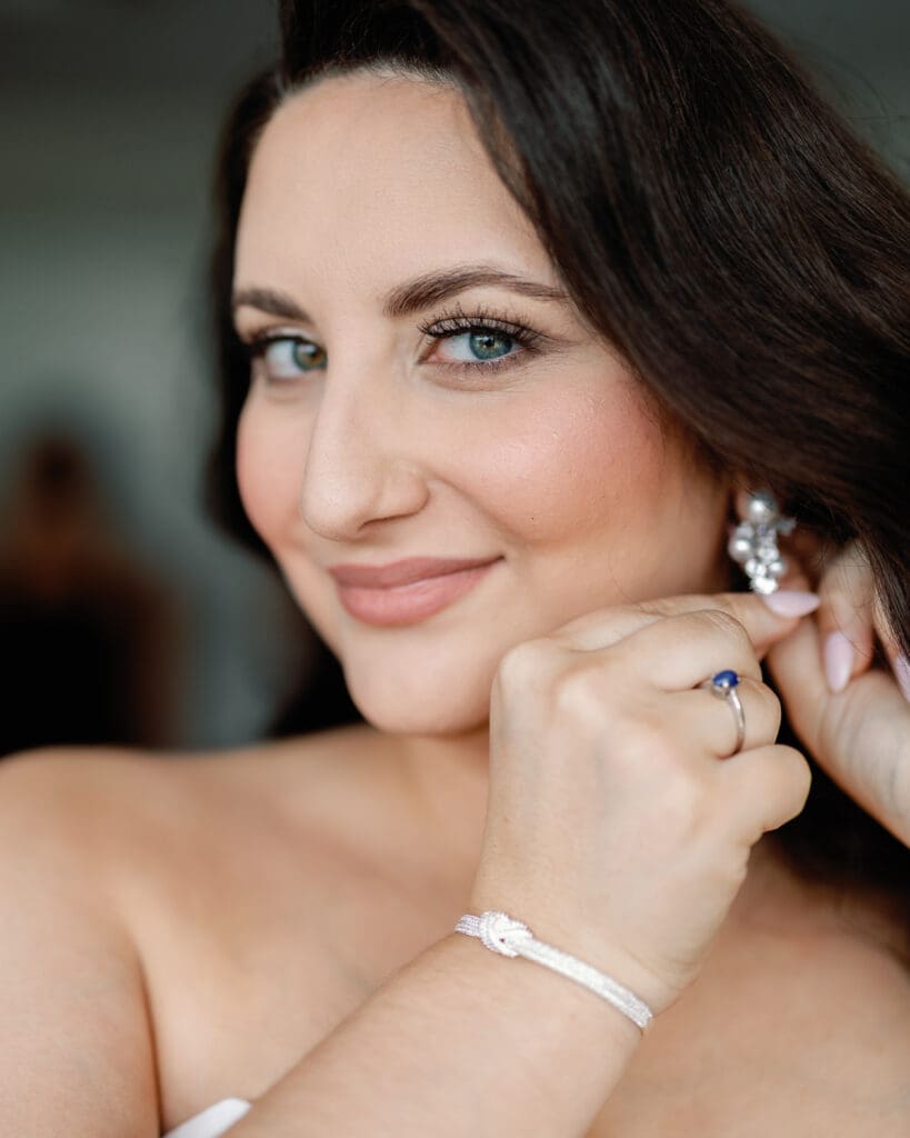 Bride adjusting earring close-up portrait