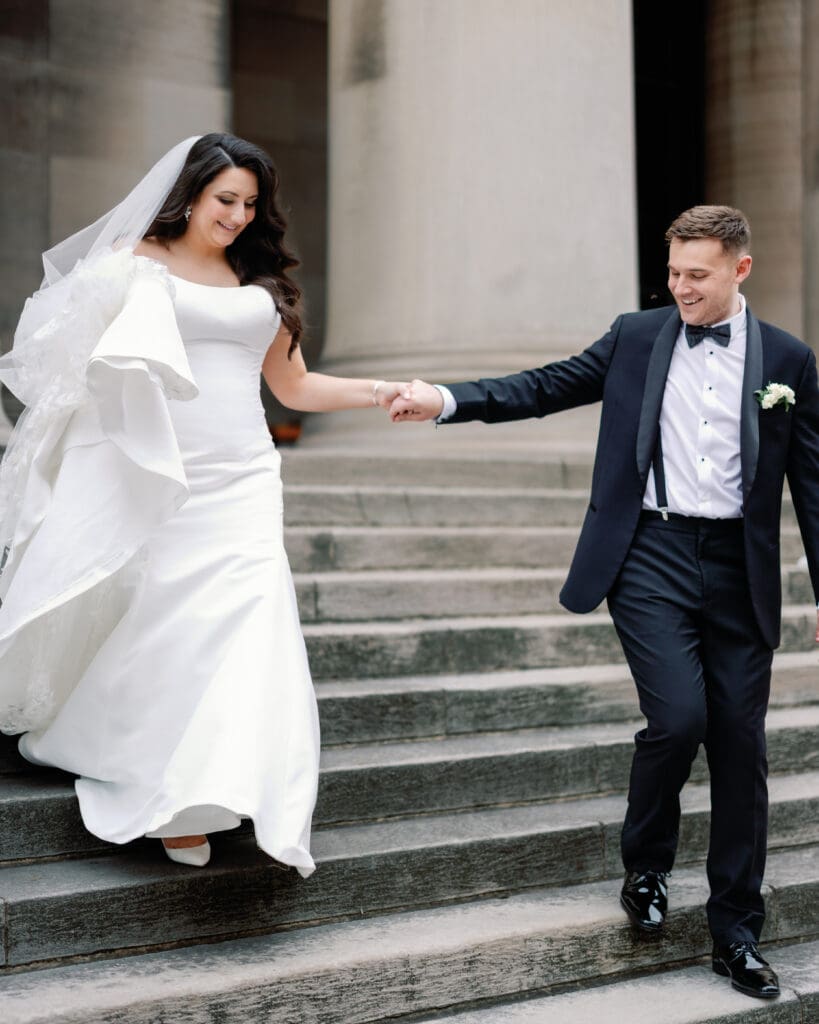 Bride and groom walking down steps together