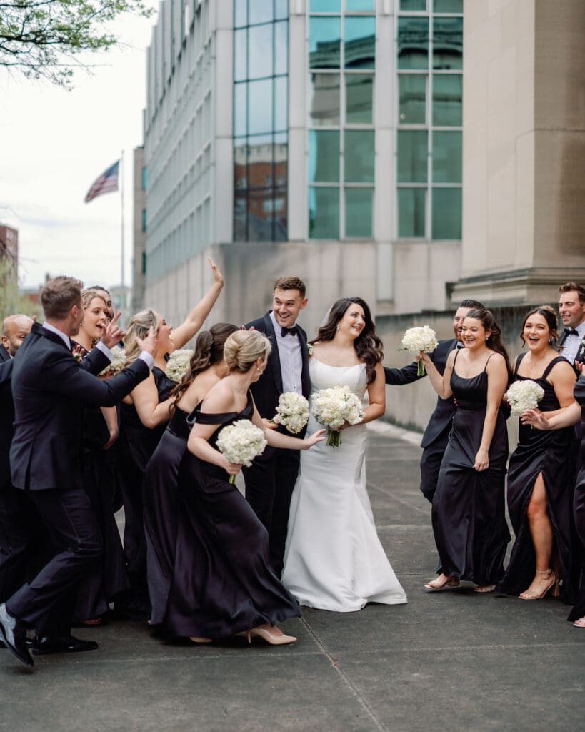 Wedding party cheering and celebrating outdoors