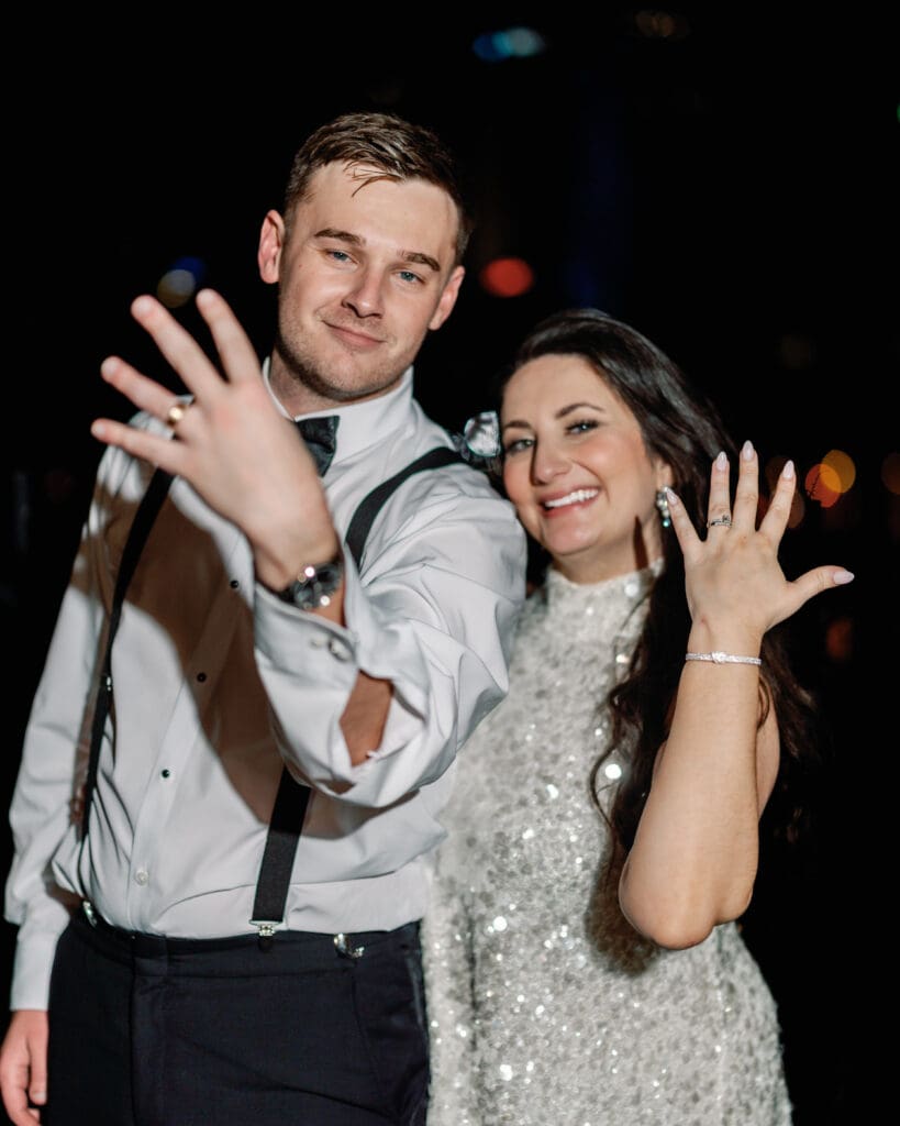 Couple holding hands showing wedding rings