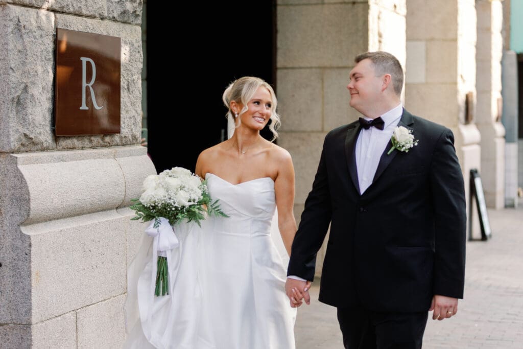 Bride and groom walking hand in hand outside Renaissance Hotel Pittsburgh wedding