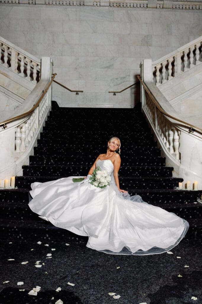 Bride sitting on grand staircase for elegant wedding portrait at Renaissance Hotel Pittsburgh