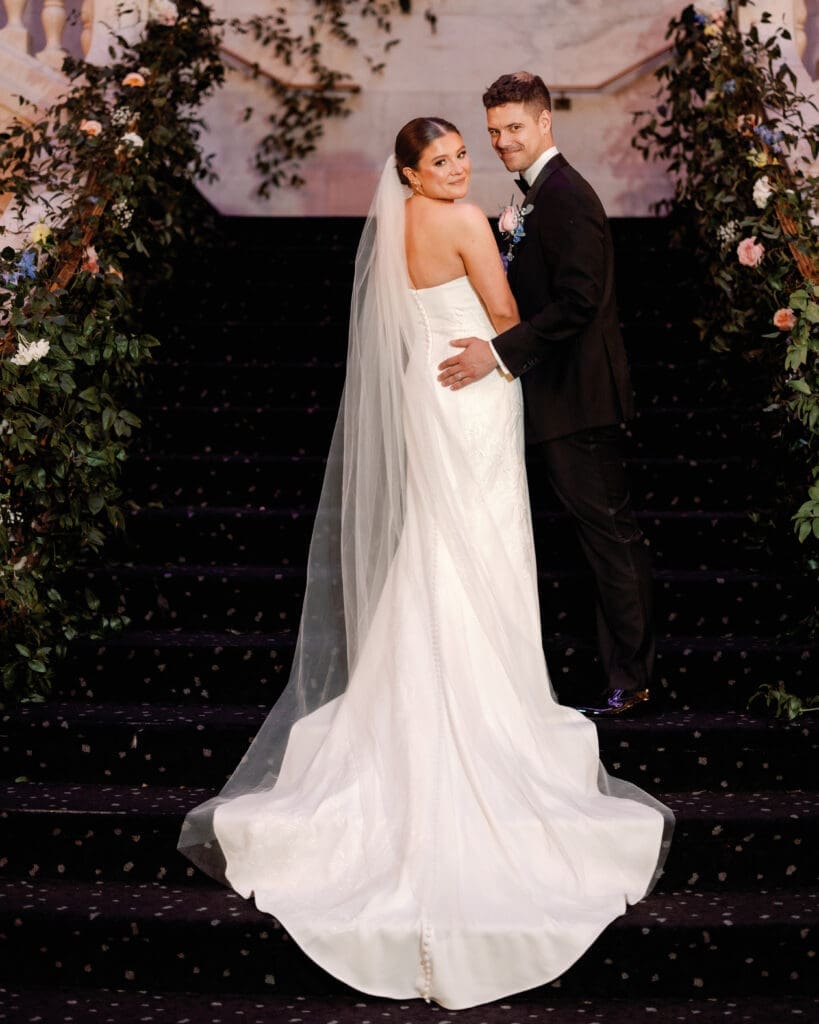 Bride and groom posing on staircase with veil flowing during Renaissance Hotel Pittsburgh wedding