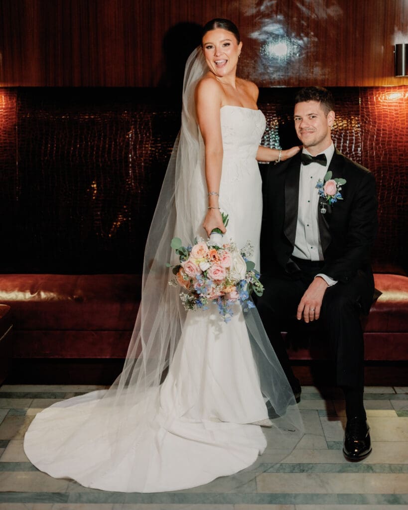 Bride and groom posing together with bouquet during reception at Renaissance Hotel Pittsburgh