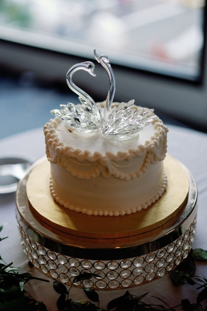 Wedding cake with swan topper displayed at Renaissance Hotel Pittsburgh reception