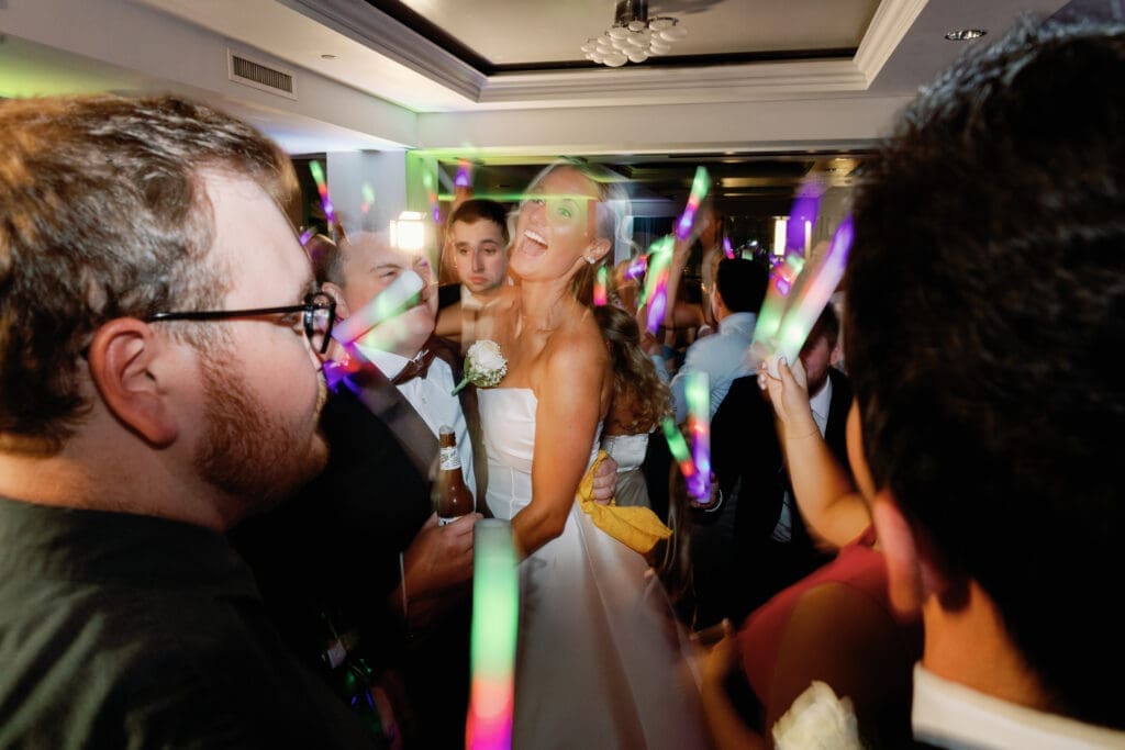 Bride dancing with guests holding glow sticks at Renaissance Hotel Pittsburgh reception