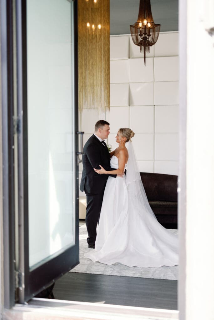 Bride and groom framed in doorway during wedding portraits at Renaissance Hotel Pittsburgh